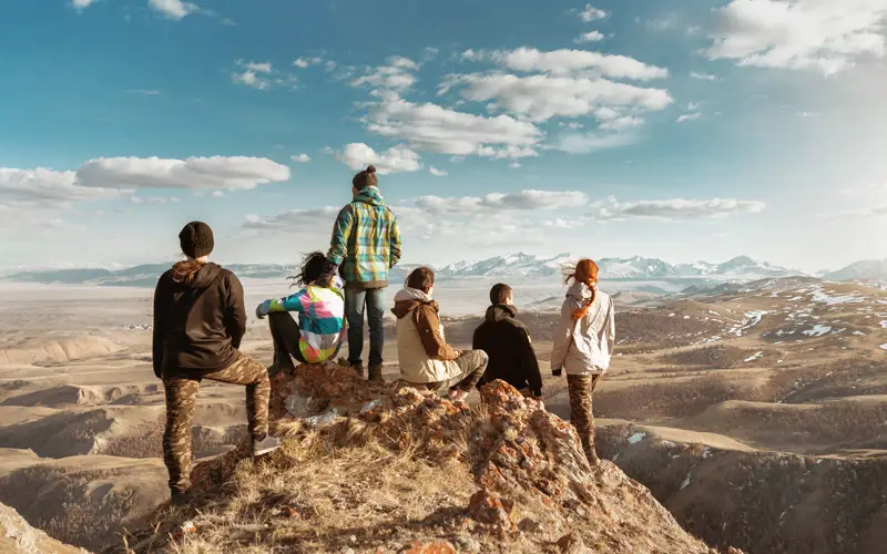 A group looking out over mountains